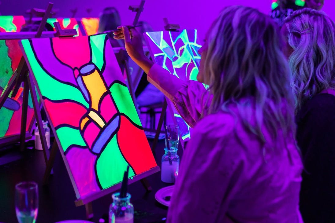 people painting under uv lights